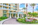 Inviting condo entrance with manicured landscaping, a porte-cochère, and elegant architectural details at 130 Riviera Dunes Way # 502, Palmetto, FL 34221