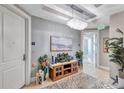 Elegant condo hallway featuring stylish decor, a decorative chandelier, and neutral colors at 130 Riviera Dunes Way # 502, Palmetto, FL 34221