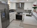 Updated kitchen featuring stainless steel appliances, white cabinetry, and modern countertops at 1414 58Th W St # 1414, Bradenton, FL 34209