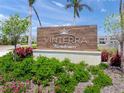 Community sign featuring 'Vinterra Townhomes' with manicured greenery and a bright, sunny sky at 15051 Ginetti St, Nokomis, FL 34275