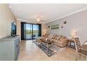 Comfortable living room featuring tile floors, a ceiling fan and a scenic balcony view at 16804 Vardon Ter # 205, Bradenton, FL 34211