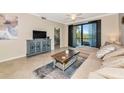 Comfortable living room featuring a large sectional, tile floors and a scenic balcony at 16804 Vardon Ter # 205, Bradenton, FL 34211