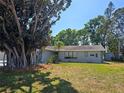 Charming single-story home with mature landscaping, including a large tree in the front yard at 2204 34Th W St, Bradenton, FL 34205