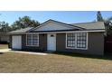 Charming exterior of home with attached garage and well-maintained yard at 2231 Lockwood Meadows Way, Sarasota, FL 34234