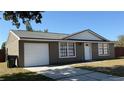 Charming exterior of home with attached garage and well-maintained yard at 2231 Lockwood Meadows Way, Sarasota, FL 34234