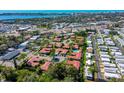 Birds eye view showcases residential community with a shared pool, mature trees, and lovely water views at 2259 Pueblo Ln # V38, Sarasota, FL 34231