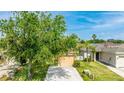 Attractive single-story home with a two car garage, green lawn, and mature trees at 2344 28Th E Ave, Palmetto, FL 34221
