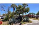 View of the home from the street, highlighting the established landscaping and adjacent homes at 2448 45Th S St, St Petersburg, FL 33711