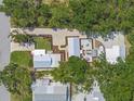 Aerial shot of a charming home, showcasing its landscaped yard, multiple patios, and outdoor living spaces at 2537 Ashton Rd, Sarasota, FL 34231