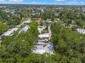 Expansive aerial view of a residential area, featuring well-maintained homes surrounded by mature trees at 2537 Ashton Rd, Sarasota, FL 34231