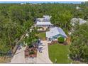 Charming single-story home with a well-manicured lawn, a brick driveway, and a welcoming front entrance at 2537 Ashton Rd, Sarasota, FL 34231