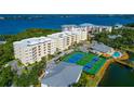 Aerial view of the community with tennis courts and nearby buildings at 260 Hidden Bay Dr # 305, Osprey, FL 34229