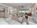 Bright living room with comfortable seating, stylish decor, and access to a spacious balcony with water views at 260 Hidden Bay Dr # 305, Osprey, FL 34229