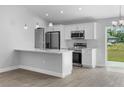 Contemporary kitchen with white cabinets, stainless steel appliances, and quartz countertops at 343 Tenk St, Port Charlotte, FL 33953