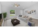 Bright living room with neutral color scheme, ceiling fan, and large window with a view at 343 Tenk St, Port Charlotte, FL 33953