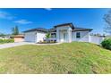 Inviting home showcasing a well-manicured lawn, bright white exterior, and neat landscaping at 380 Holly Rd, Venice, FL 34293