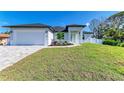 Charming single-story home with a fresh green lawn, clean white exterior, and well-kept landscaping at 380 Holly Rd, Venice, FL 34293