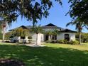 A charming one-story home with a well-manicured lawn and mature landscaping at 3806 155Th E Ave, Parrish, FL 34219