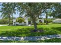A well-manicured lawn and mature landscaping surround this charming home at 3806 155Th E Ave, Parrish, FL 34219