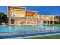 Luxury waterfront home featuring an inviting pool with comfortable outdoor seating at 4123 Bay Shore Rd, Sarasota, FL 34234