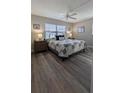 Cozy bedroom featuring a ceiling fan and neutral decor at 4158 Tamiami Trl # V1, Port Charlotte, FL 33952