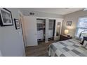 Bedroom with closet and shelving and laminate wood floors at 4158 Tamiami Trl # V1, Port Charlotte, FL 33952