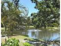 Scenic pond view with fountain, dock and mature trees at 425 30Th W Ave # C204, Bradenton, FL 34205