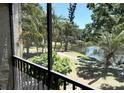Balcony view of a picturesque pond with fountain and landscaping at 425 30Th W Ave # C204, Bradenton, FL 34205