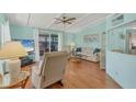 Cozy living room with hardwood floors, blue walls, and a sliding glass door to screened room at 4519 14Th E St, Ellenton, FL 34222