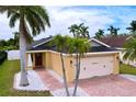 Beautiful single Gathering home featuring an attached two-car garage, palm trees and a lush green lawn at 4826 San Ortebello Dr, Bradenton, FL 34208