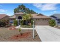 Inviting home featuring a well-maintained lawn, mature landscaping, and a two-car garage at 4926 72Nd E St, Bradenton, FL 34203