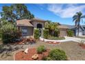 Charming single-story home with a manicured lawn, beautiful landscaping, and a two-car garage at 4926 72Nd E St, Bradenton, FL 34203
