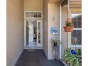 Inviting front entry featuring a decorative welcome sign, hanging flower pots, and an open glass door at 4926 72Nd E St, Bradenton, FL 34203