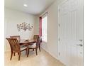 Cozy dining area with a wooden table, seating for four, and a decorative tree art piece on the wall at 5102 98Th E Ave, Parrish, FL 34219