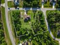 Sprawling property featuring mature trees surrounding the residence at 5955 Ferendina St, North Port, FL 34291