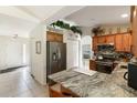 Well-appointed kitchen with stainless steel appliances and solid surface counters at 5955 Ferendina St, North Port, FL 34291
