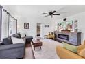 Bright living room featuring an electric fireplace, hardwood floors, and contemporary furnishings at 6013 Murdock Ave, Sarasota, FL 34231