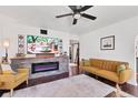 Bright living room featuring an electric fireplace, hardwood floors, and contemporary furnishings at 6013 Murdock Ave, Sarasota, FL 34231