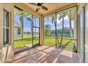 Relaxing screened-in lanai with views of the beautiful lake and swaying palm trees at 6520 38Th E Ln, Sarasota, FL 34243
