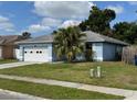 Single-story home with a two car garage and a well-maintained lawn at 6928 43Rd E Ct, Sarasota, FL 34243