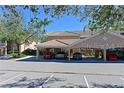 Attractive condo building showing attached covered parking and beautiful landscaping on a sunny day at 803 Fairwaycove Ln # 102, Bradenton, FL 34212