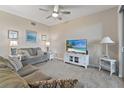 Comfortable living room featuring a plush sofa, entertainment center, and a cozy atmosphere for relaxation at 803 Fairwaycove Ln # 102, Bradenton, FL 34212