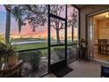 Screened patio offers serene views of the golf course and landscaping at sunset at 803 Fairwaycove Ln # 102, Bradenton, FL 34212
