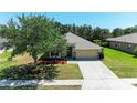 Well-maintained single Gathering home featuring a two-car garage and landscaped front yard at 9819 46Th E Ct, Parrish, FL 34219
