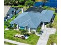 Aerial view of landscaped single-Gathering home with blue roof and manicured lawn at 1008 83Rd Nw St, Bradenton, FL 34209