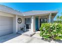 Welcoming front entrance features a bright blue door and lovely landscaping at 1008 83Rd Nw St, Bradenton, FL 34209