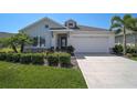 Charming single-Gathering home featuring a well-manicured lawn and a two-car garage with curb appeal at 11713 Chevelon Ln, Parrish, FL 34219