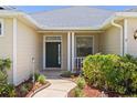 Close-up of the front door with charming landscaping and a well-maintained walkway to the home at 12014 Beeflower Dr, Lakewood Ranch, FL 34202