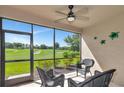Relaxing screened-in lanai with comfortable wicker seating and a scenic golf course view, perfect for enjoying the outdoors at 12720 Sorrento Way # 103, Bradenton, FL 34211