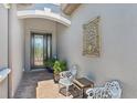 Inviting entryway featuring a decorative front door, stylish seating, and custom wall art at 13786 Vancanza Dr, Venice, FL 34293